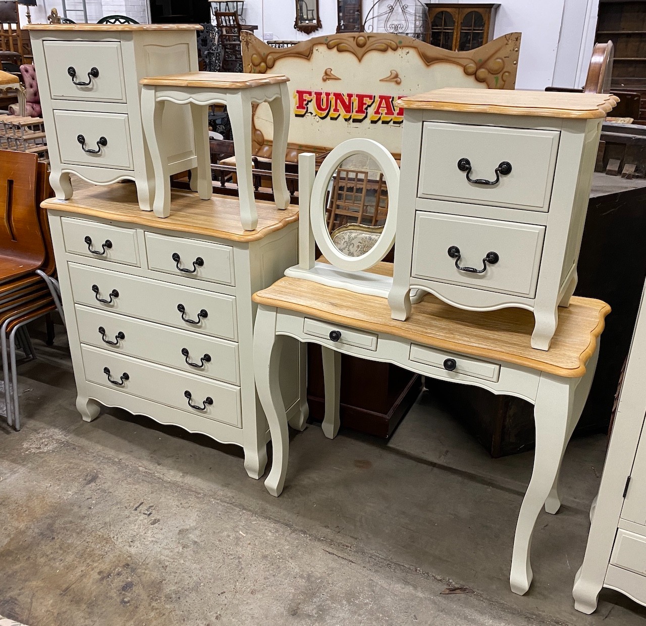 An oak and eau de nil painted wood six piecebedroom suite, from 'Oak Furniture Land' comprising a chest of drawers, dressing table and stool, a mirror and two bedside chests